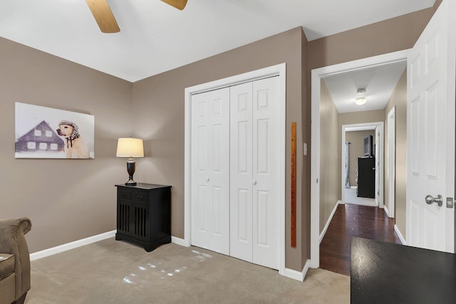 living area with carpet flooring and ceiling fan