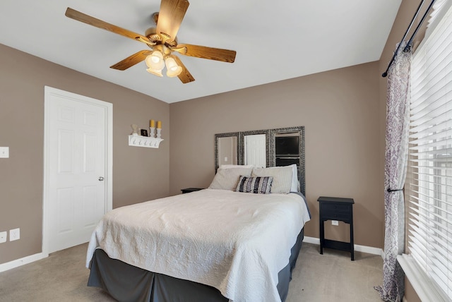 bedroom with light colored carpet and ceiling fan