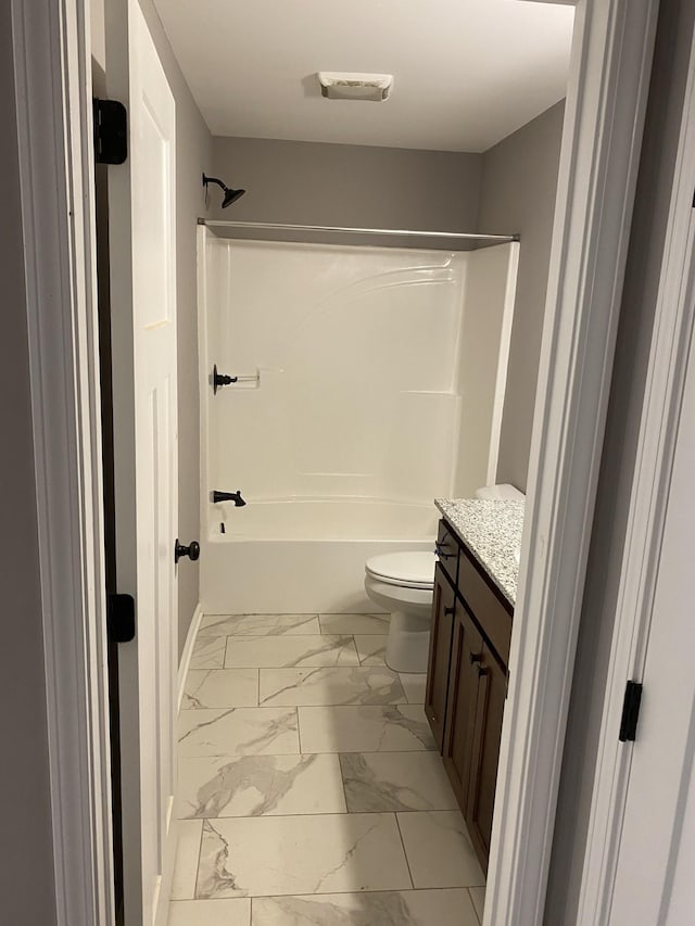 full bathroom featuring vanity, washtub / shower combination, and toilet