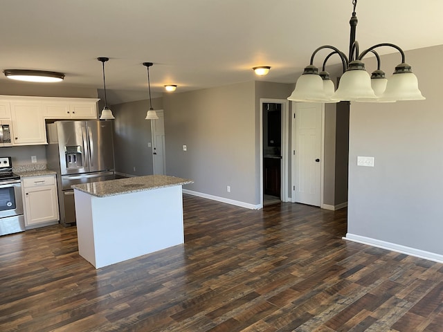 kitchen with a kitchen island, pendant lighting, white cabinetry, dark hardwood / wood-style flooring, and stainless steel appliances