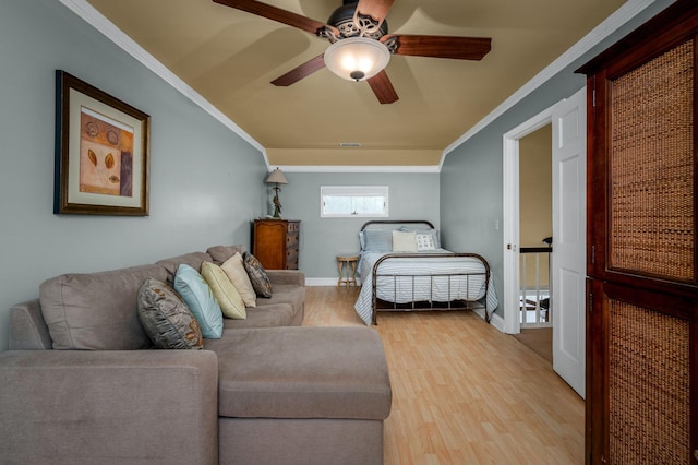 bedroom featuring ceiling fan, light hardwood / wood-style floors, and ornamental molding