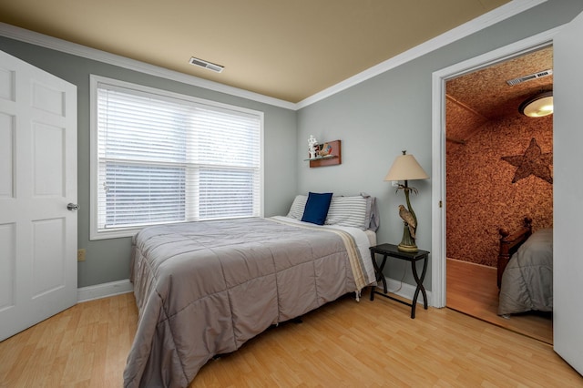 bedroom featuring hardwood / wood-style flooring and ornamental molding