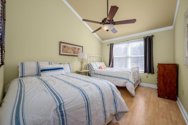 bedroom with ceiling fan, lofted ceiling, ornamental molding, and light hardwood / wood-style flooring