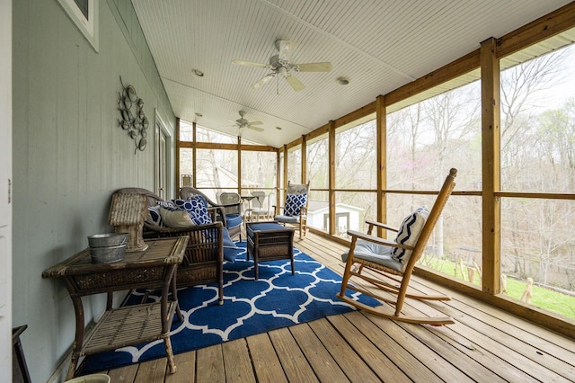 sunroom with ceiling fan and vaulted ceiling