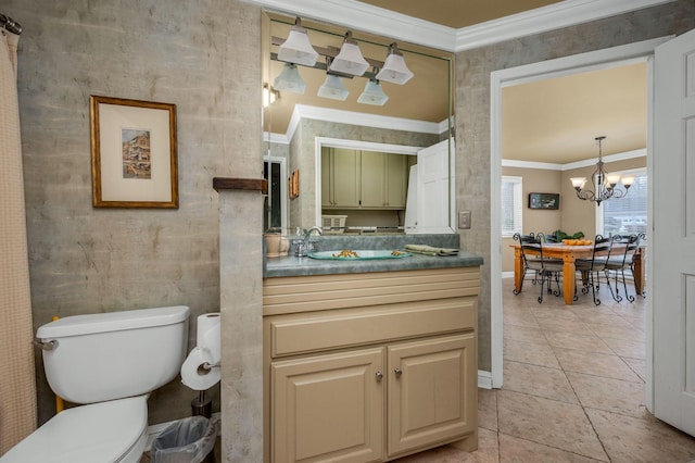 bathroom featuring tile patterned flooring, a chandelier, toilet, vanity, and ornamental molding