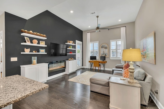 living room with ceiling fan and dark hardwood / wood-style flooring