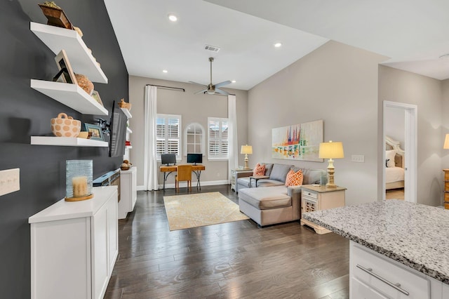 living room featuring ceiling fan, dark hardwood / wood-style flooring, and vaulted ceiling