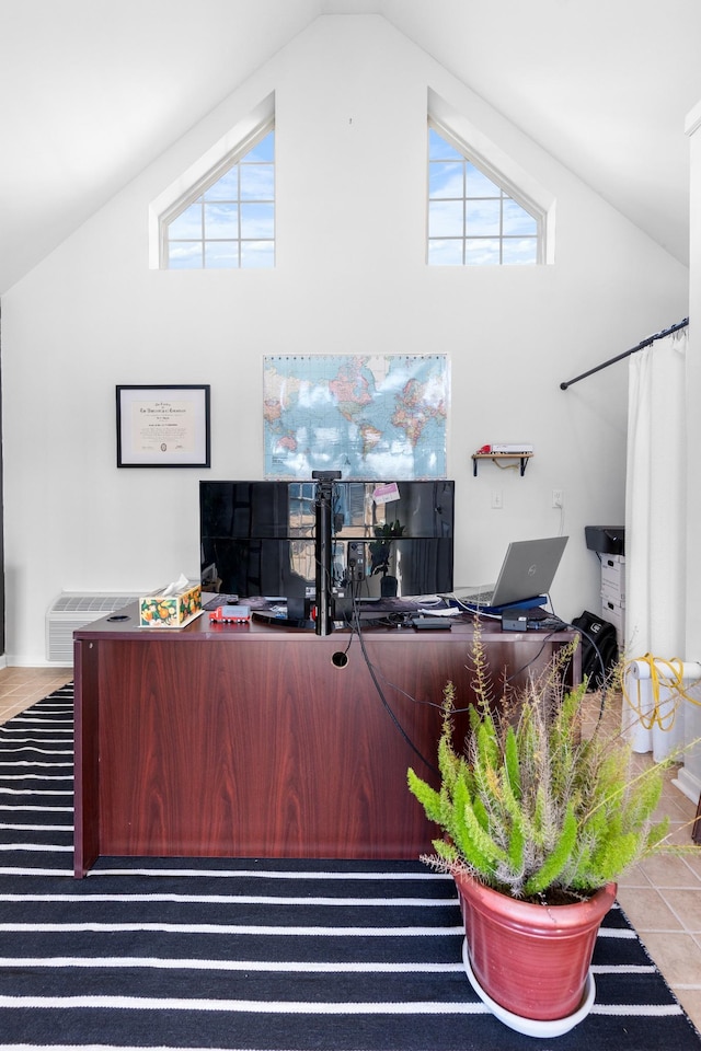 office with light tile patterned floors and high vaulted ceiling