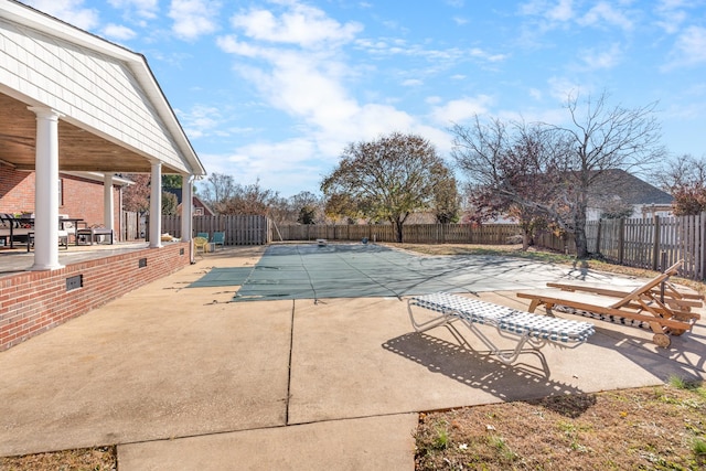 view of swimming pool with a patio