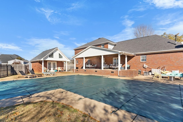 view of pool with an outbuilding and a patio