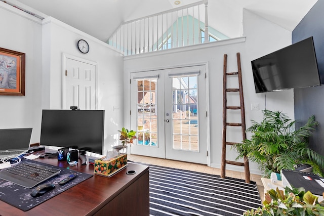 home office featuring high vaulted ceiling, french doors, and light wood-type flooring