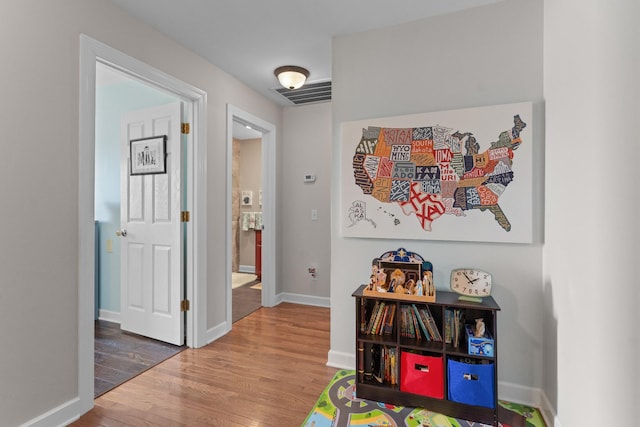 corridor with hardwood / wood-style floors