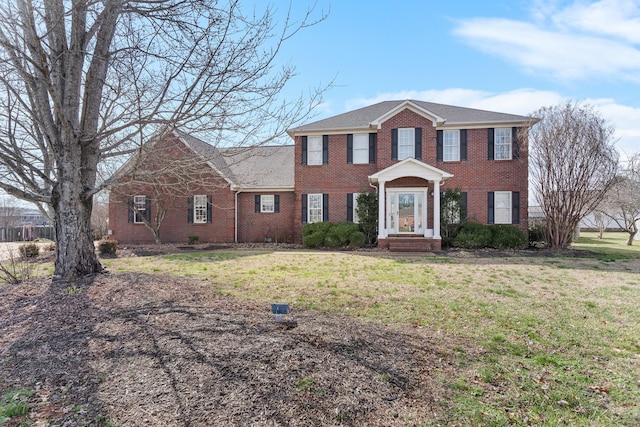 colonial home with a front lawn