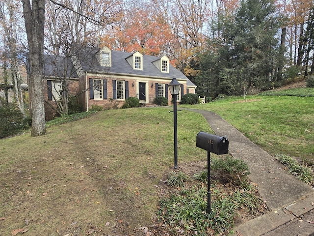 cape cod-style house featuring a front yard