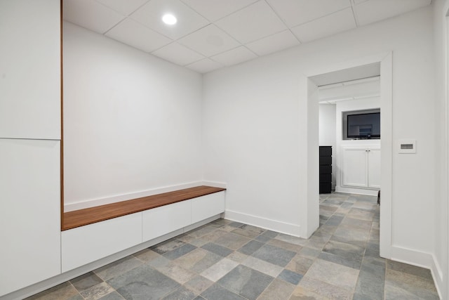 hallway with a paneled ceiling