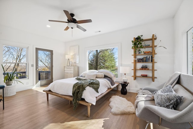 bedroom with ceiling fan, access to exterior, and light wood-type flooring