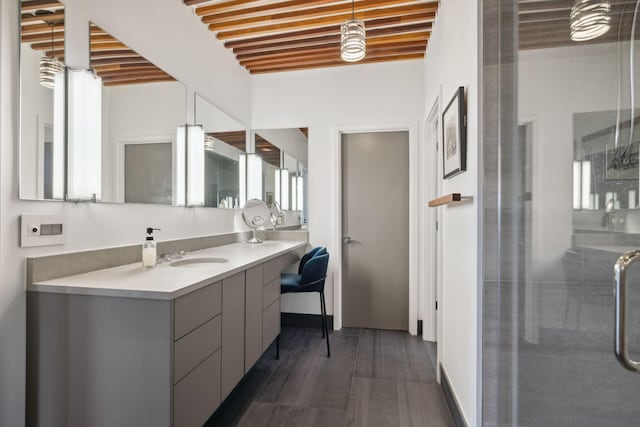 bathroom featuring hardwood / wood-style flooring, vanity, and walk in shower