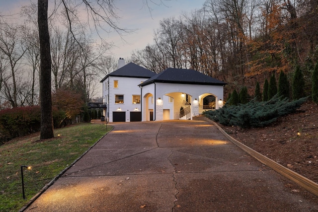 property exterior at dusk with a garage