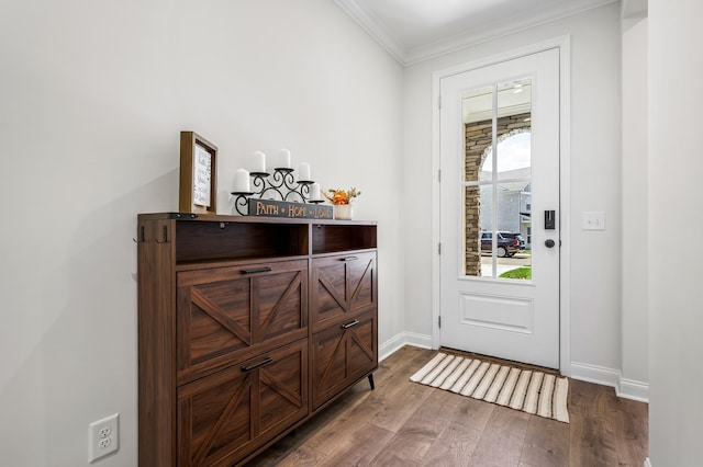 doorway to outside featuring dark hardwood / wood-style floors and crown molding