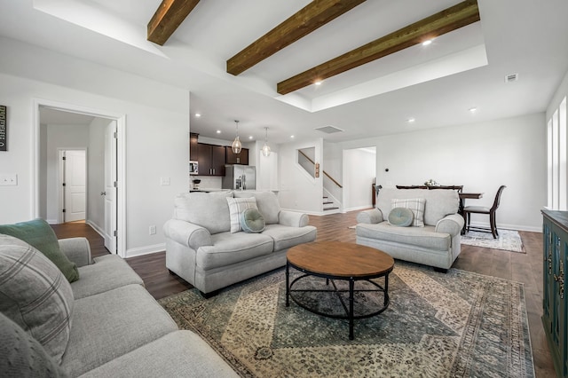 living room with beamed ceiling and dark wood-type flooring