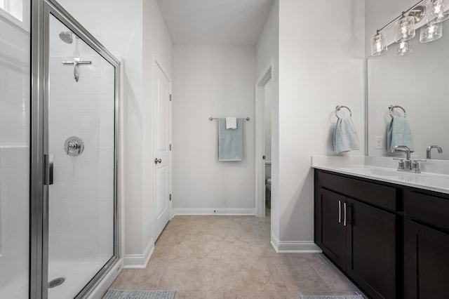 bathroom with vanity, toilet, and walk in shower