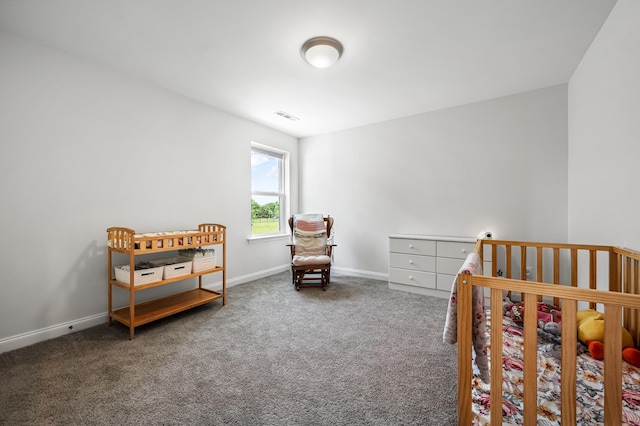 carpeted bedroom featuring a crib