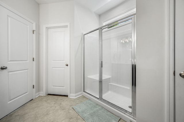 bathroom featuring a shower with shower door