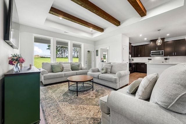 living room with hardwood / wood-style flooring and beamed ceiling