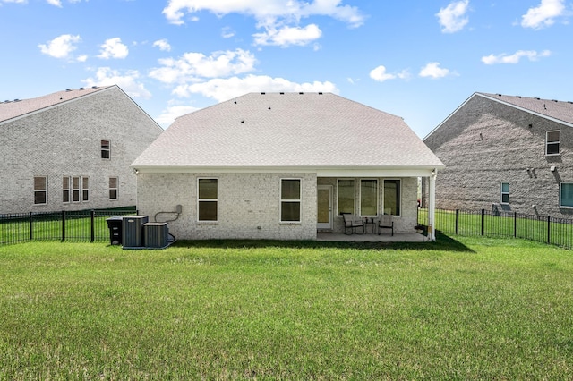 back of house with a lawn, a patio, and central AC