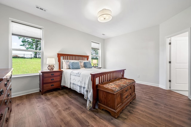 bedroom with dark wood-type flooring