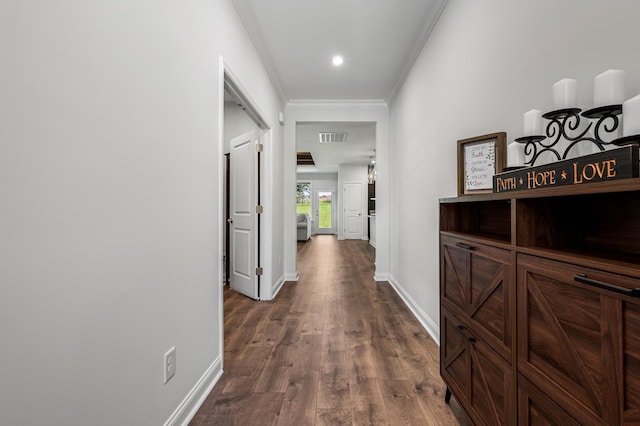 hallway featuring dark hardwood / wood-style floors and ornamental molding