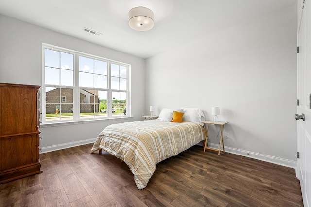 bedroom with dark wood-type flooring