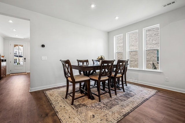 dining area featuring dark wood-type flooring