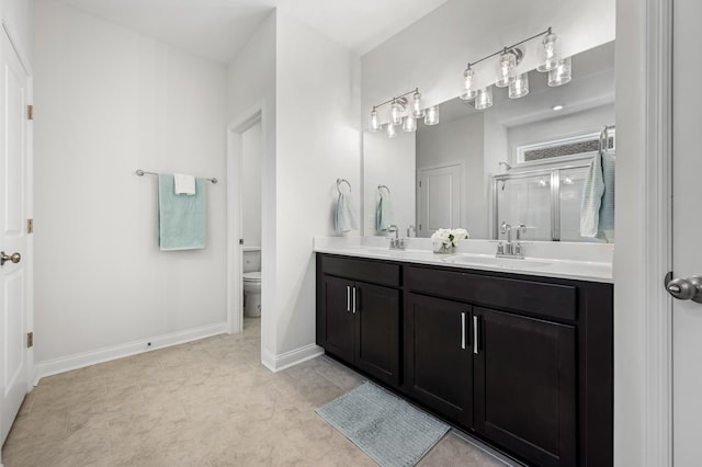 bathroom with vanity, toilet, and an enclosed shower