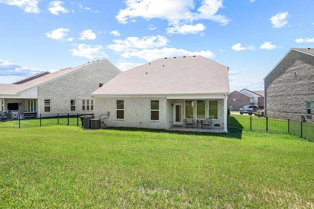 rear view of property featuring a yard and a patio