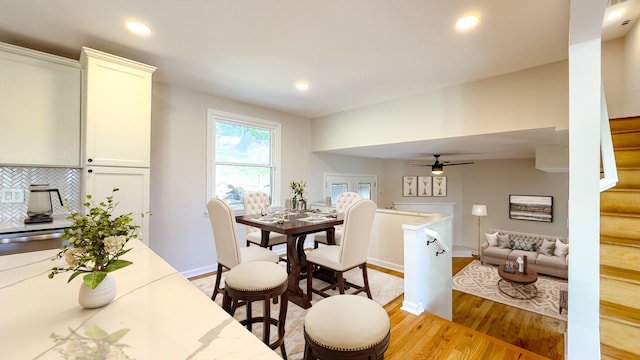 dining room featuring light hardwood / wood-style flooring and ceiling fan