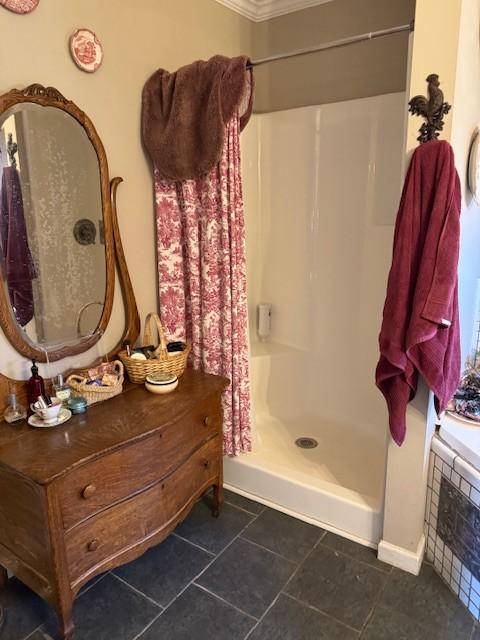 bathroom featuring a shower, tile patterned floors, and ornamental molding