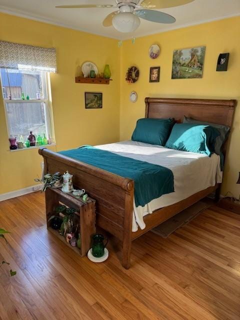 bedroom with ceiling fan and wood-type flooring