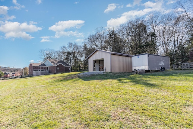 view of yard featuring a garage and an outdoor structure