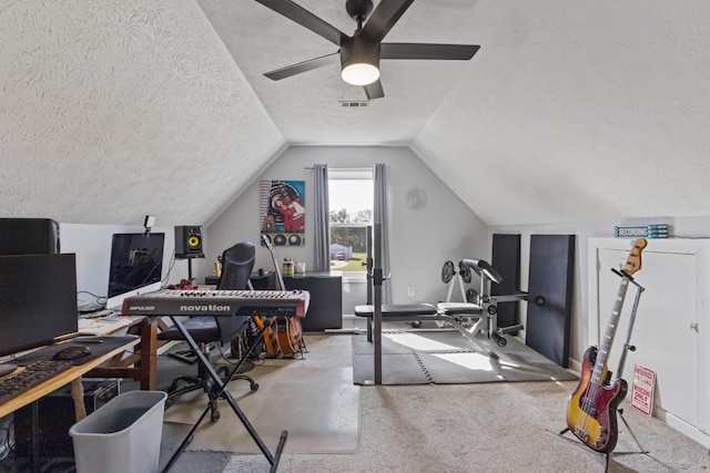 carpeted office space with a textured ceiling, ceiling fan, and lofted ceiling