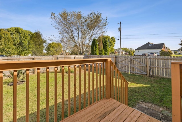 wooden deck featuring a yard