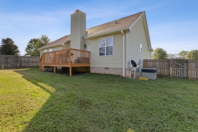 rear view of property with a lawn and a wooden deck