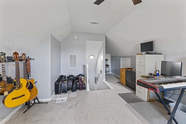 carpeted office space featuring a textured ceiling, vaulted ceiling, and ceiling fan