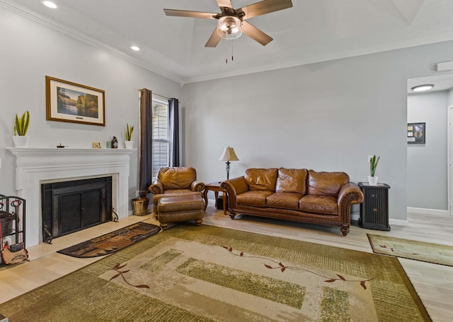 living room with ceiling fan, wood-type flooring, and crown molding