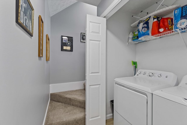 laundry area with carpet flooring, a textured ceiling, and independent washer and dryer