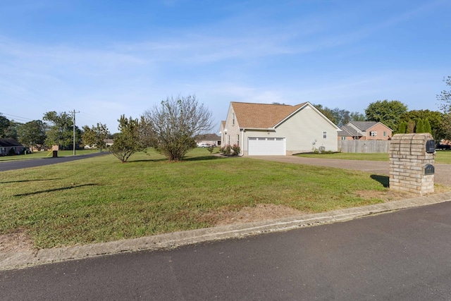 view of front of property with a front yard and a garage