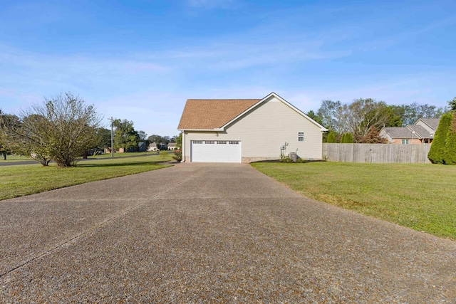 view of property exterior with a yard and a garage