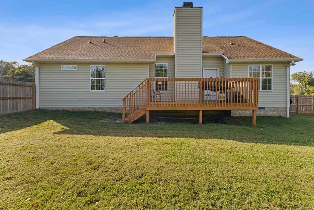 back of house featuring a lawn and a wooden deck