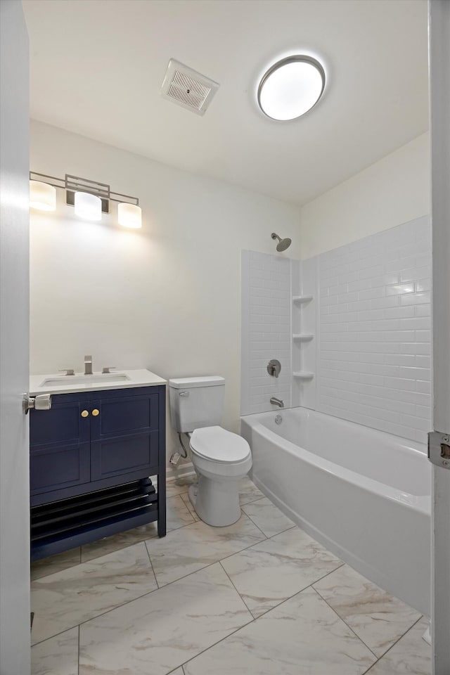 full bathroom featuring toilet, vanity, and tiled shower / bath