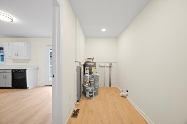 washroom featuring light hardwood / wood-style floors and electric water heater